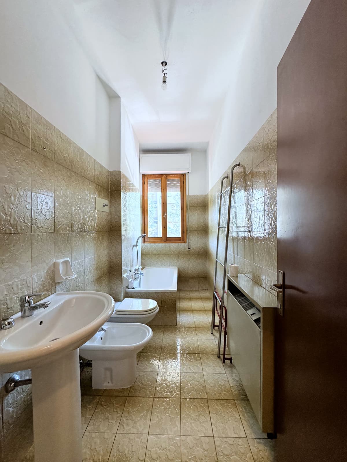 Bagno con vasca e piastrelle beige — Quadrilocale di 136 m² con box auto in Via Caravaggio