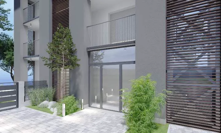 Ingresso comune vetrato con giardino